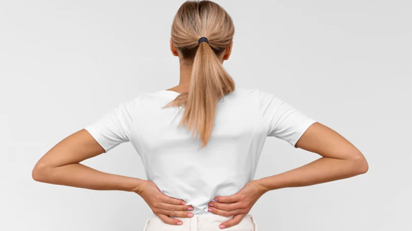 an image of a woman suffering from a lower back pain