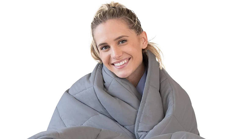 an image of a woman wrapped in luna weighted blanket