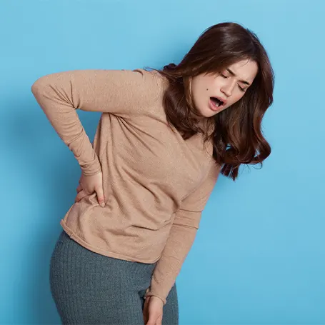 a woman bending due to suffering from a hip pain