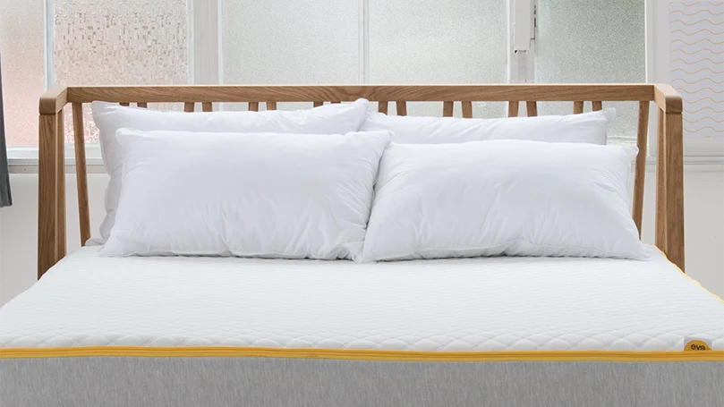 an image of eve snuggle pillow on an eve mattress