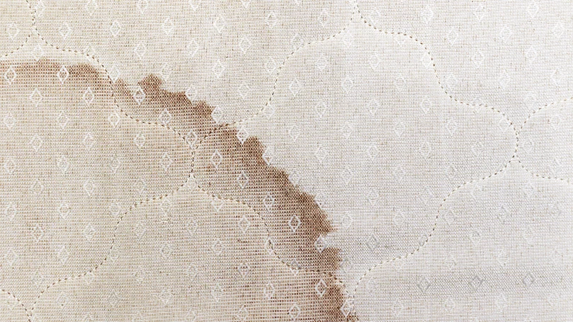 an image of yellow stains from sweat on a mattress