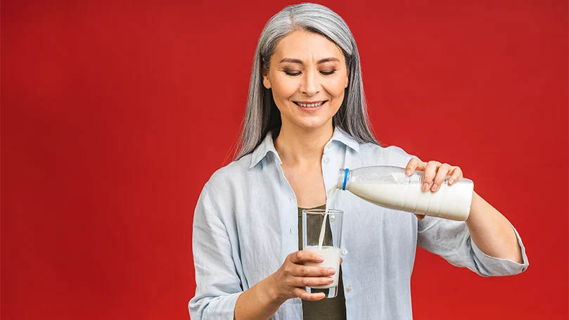 An image of a woman drinking a glass of milk.