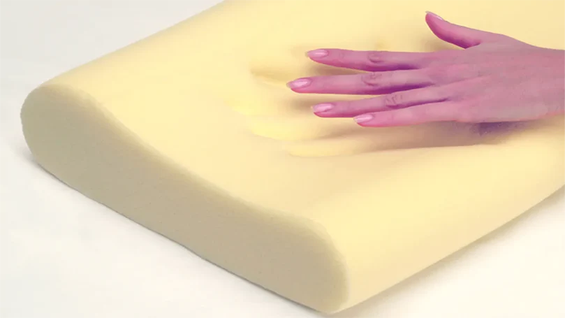 An image of a person putting their hand on the Dormeo Memosan Anatomic pillow