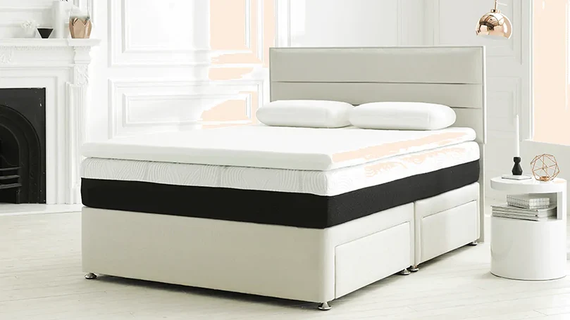 An image of Dormeo Octaspring Classic mattress topper on a mattress in a bedroom.