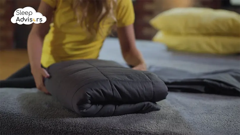 Testing of Simba Orbit weighted blanket - Charlotte folding it on a bed