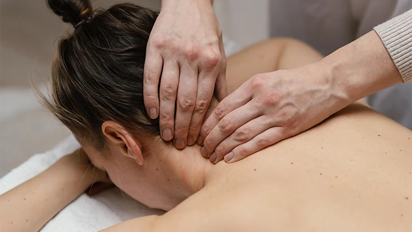 An image of a therapist massaging a woman's neck.