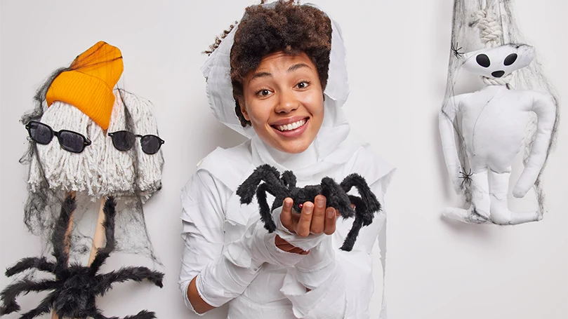an image of a woman holding a spider made of fabric