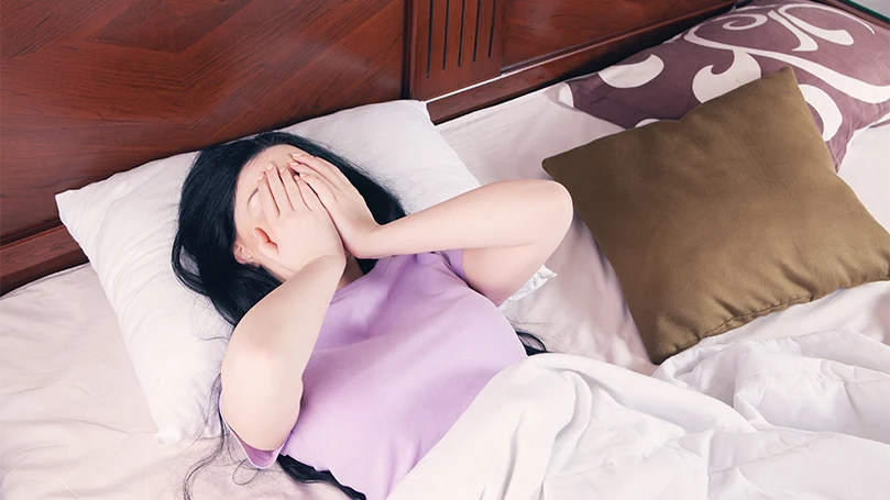 An image of a woman suffering from sleep disorders.
