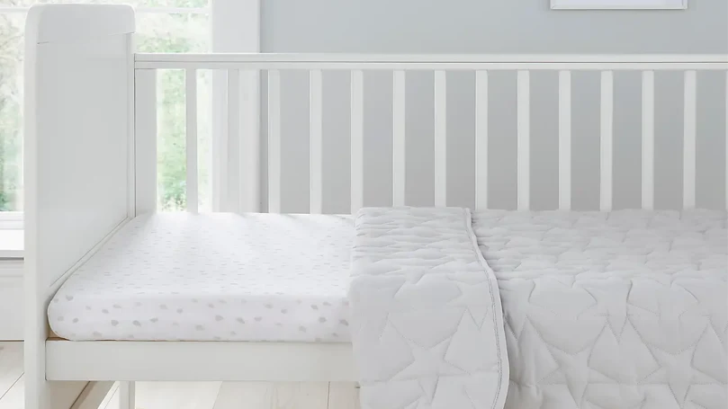 An image of White Coverless Duvet Dunelm on toddler's bed.