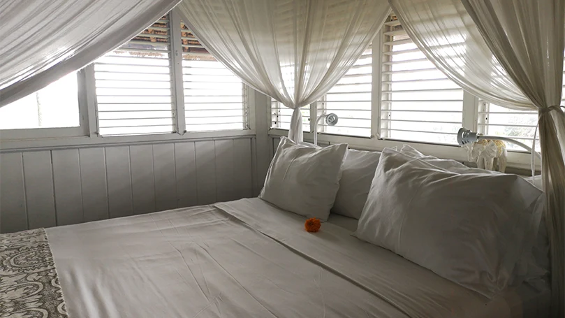 An image of a canopy bed with curtains.