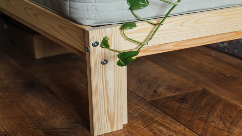 An image of a leg of a bed on the floor.