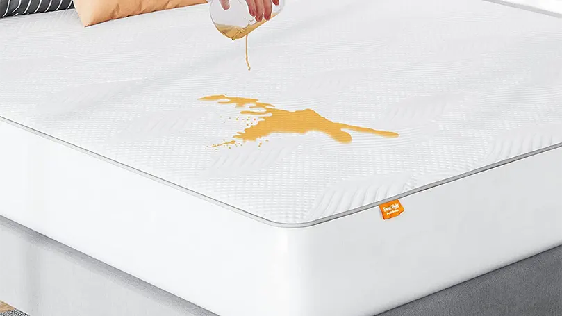 An image of a liquid spilled over Sweetnight's mattress protector.