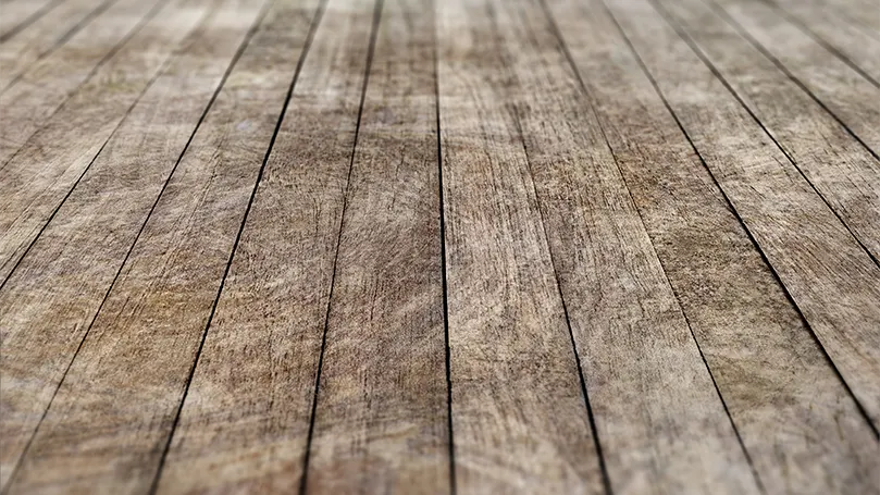 A scratched wooden floor.