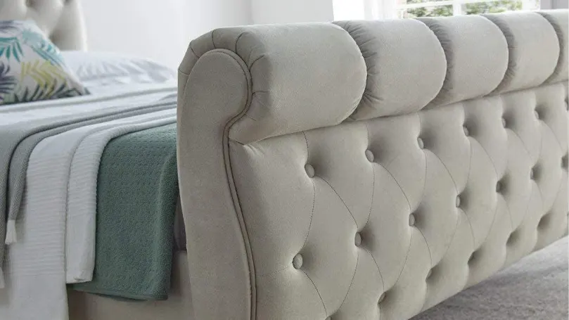 A close up image of sleigh bed footrest
