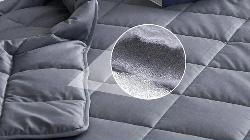 A close up image of a weighted blanket with a glass beads filling