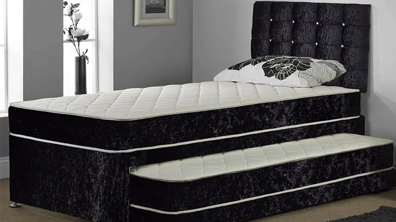 An image of an elegant black trundle bed.