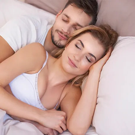 couple cuddling and sleeping