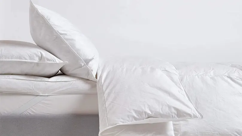 An image of Homescapes duvet on a bed with pillows.
