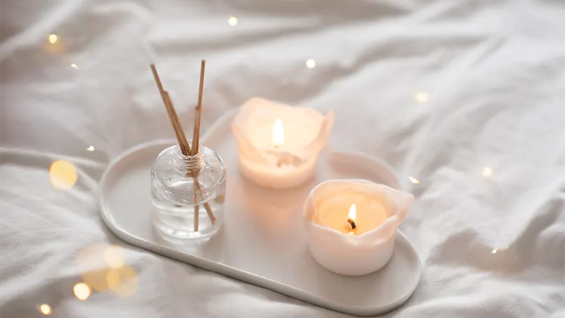 An image of a bamboo bedding with candles.