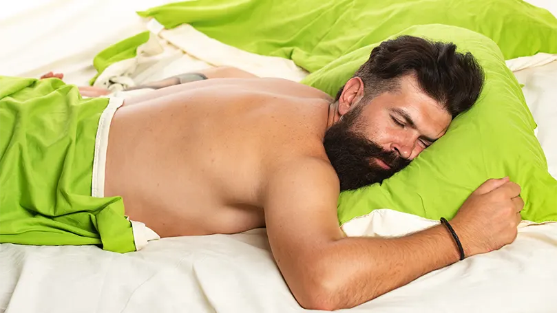An image of a bearded man in the first stage of sleep.