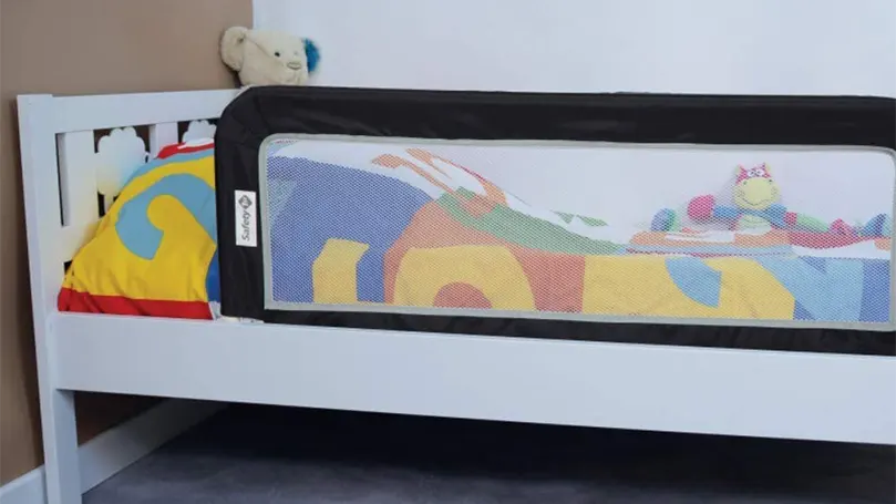 An image of a bed guard attached to a toddler's bed.