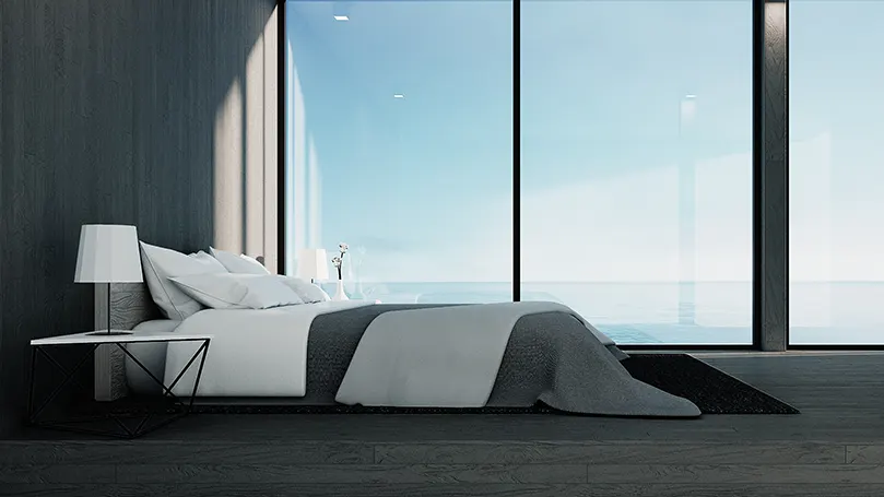 An image of a bedroom with a seaside view.
