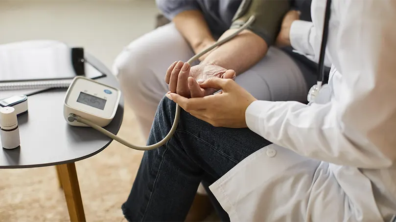 A doctor checking blood pressure.
