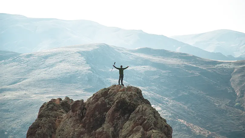 A hiker on top of a mountain.