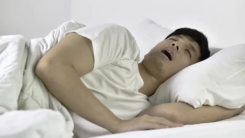 An image of a man suffering from sleep apnea.