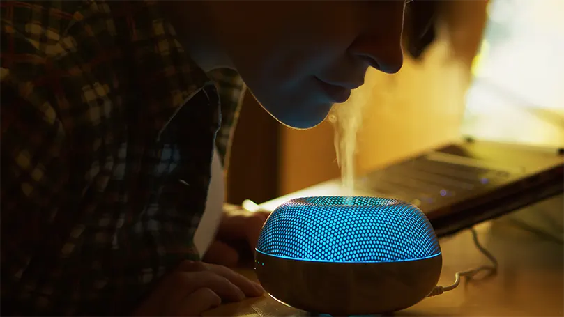 A woman steam inhaling herself on diffuser