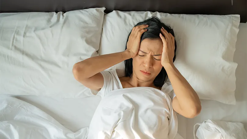 An image of a woman suffering from vertigo while sleeping.