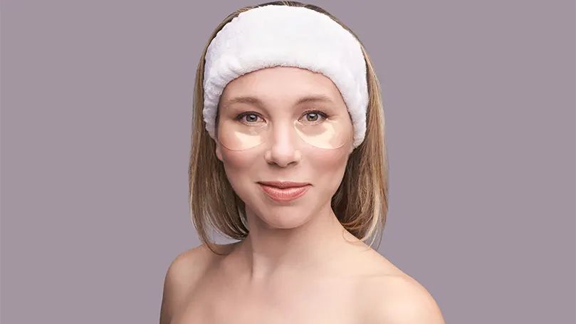 An image of a woman with anti-aging cream applied to her face