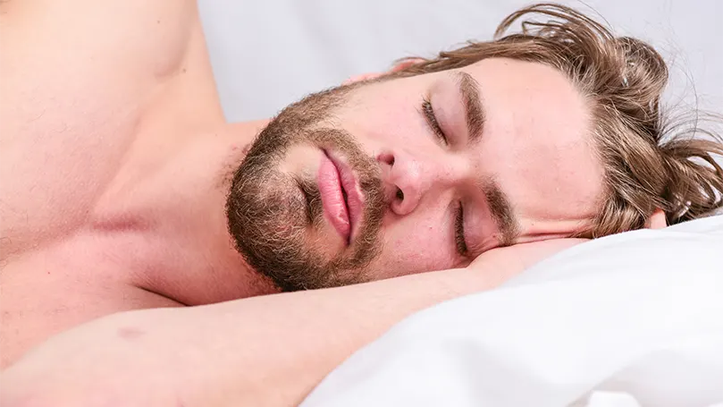 An image of a young man sleeping in a deep sleep phase.