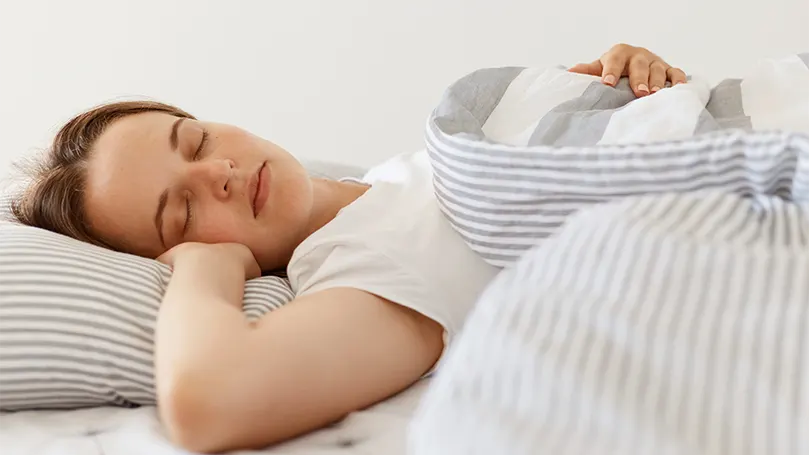 A young woman laying on side.