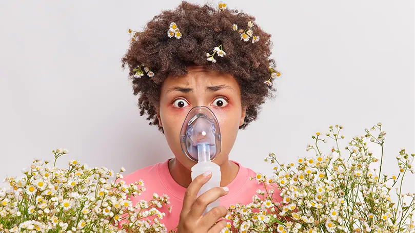 A young woman wears a breathing mask.