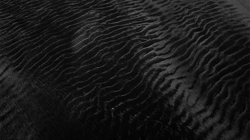 A close up image of a black velvet material.