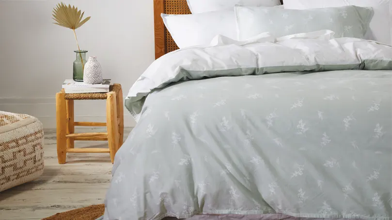 An image of grey bedding on a bed.