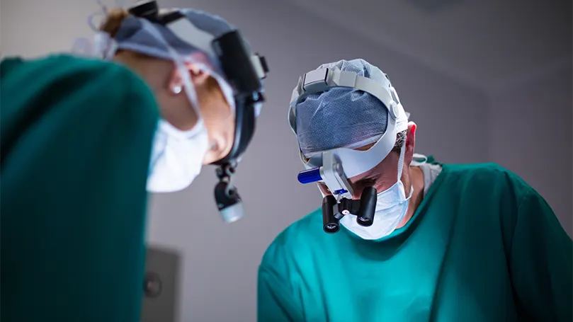 An image of surgeons performing a surgical procedure.
