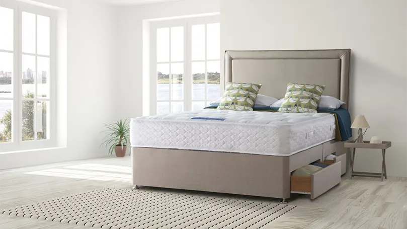 An image of Sealy Millionaire Ortho mattress in a bedroom.