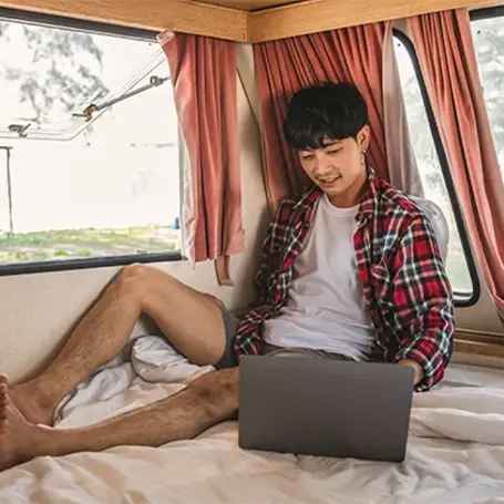 A man with laptop in an RV