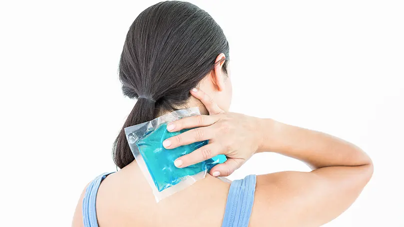 An image of a woman putting an ice pack on her neck