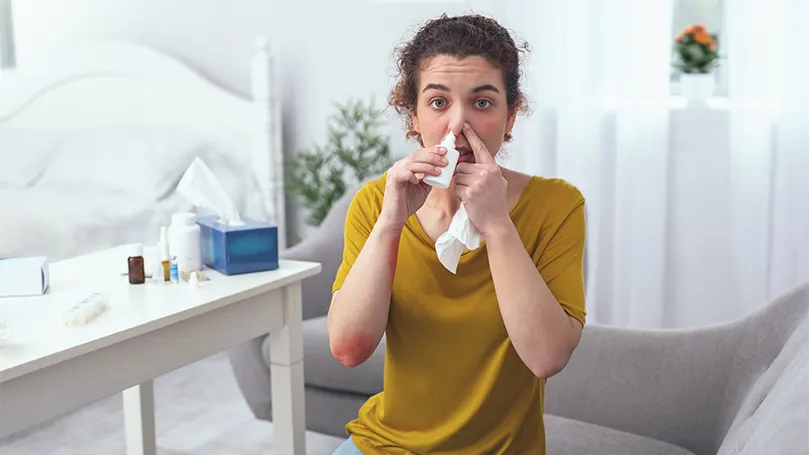 An image of a woman using a decongestant.