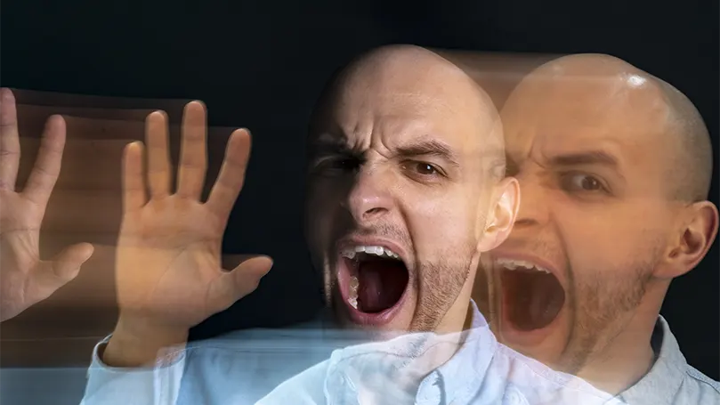 An image of a young bald man suffering from schizophrenia.
