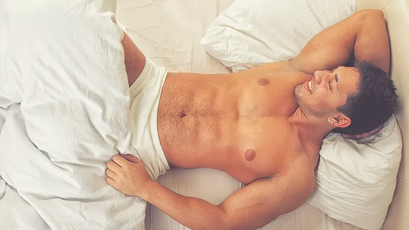 a-young-handsome-man-in-bed-in-his-underwear