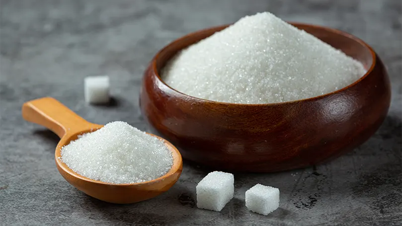A sugar in a wooden bowl.