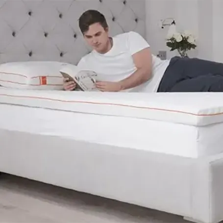 A man reading on a mattress
