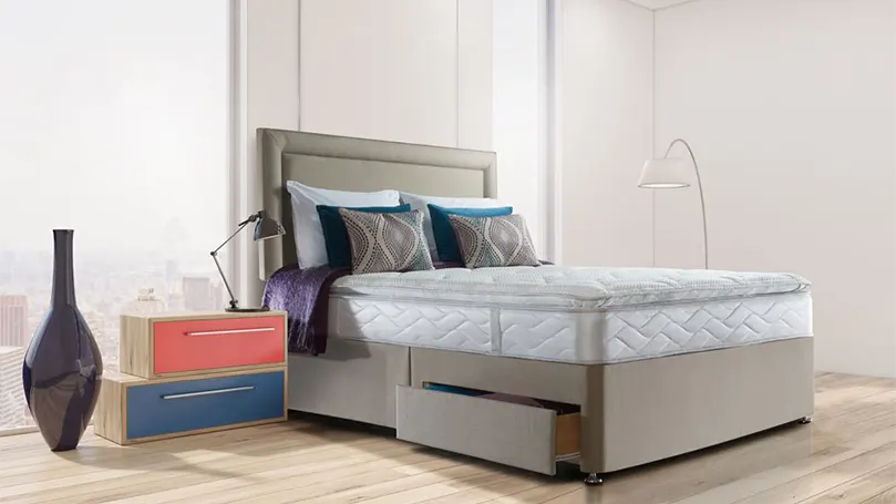 An image of Sealy Posturepedic Pearl Luxury Pillow Top mattress in a bedroom.