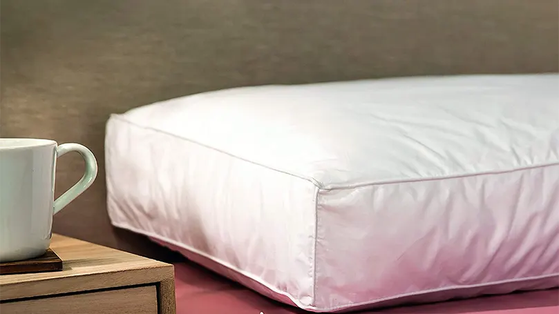 An image of Snuggledown Side Sleeper pillow on bed.