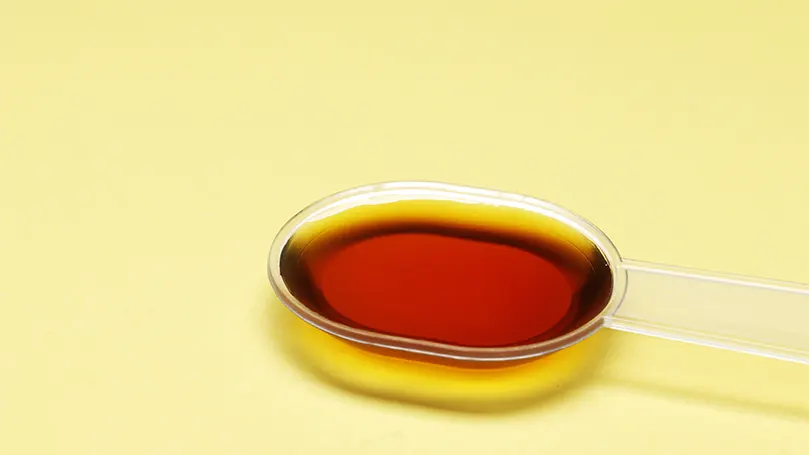 An image of a teaspoon of cough syrup.