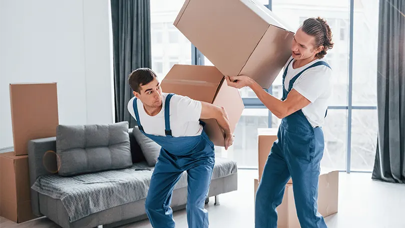 An image of two young men shipping boxes.